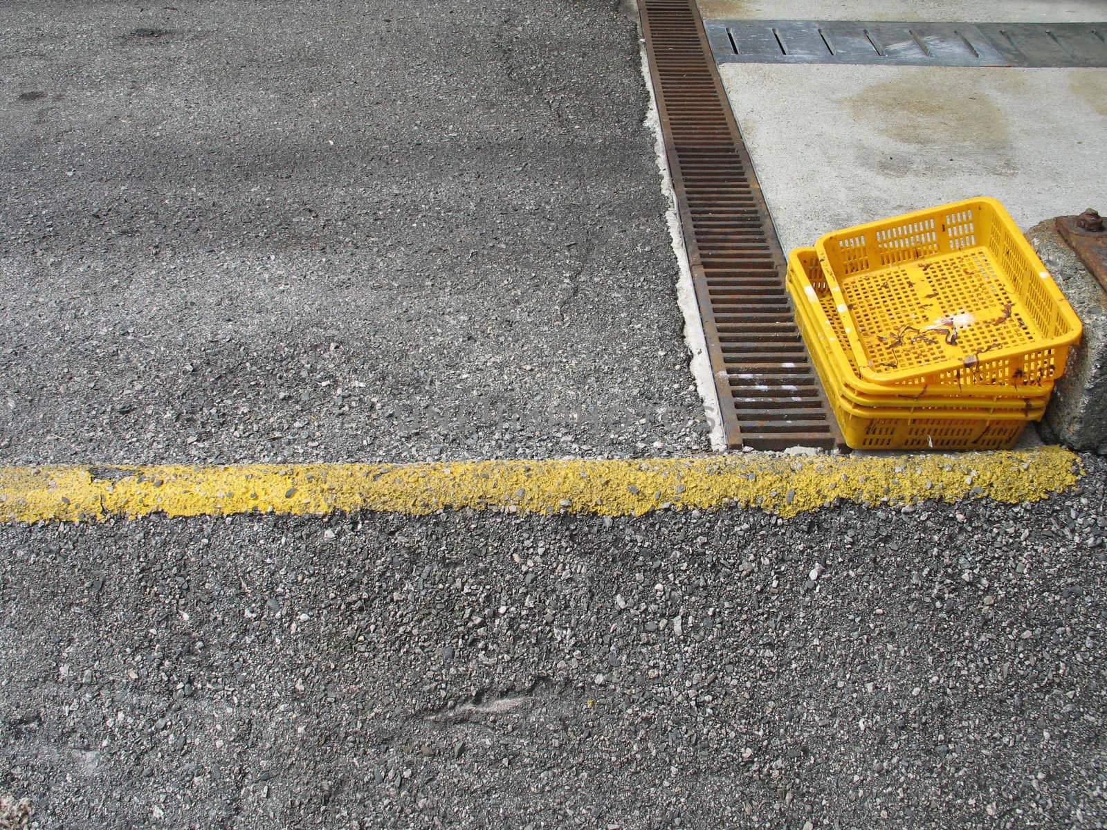 yellow trays in a parking lot by mmm