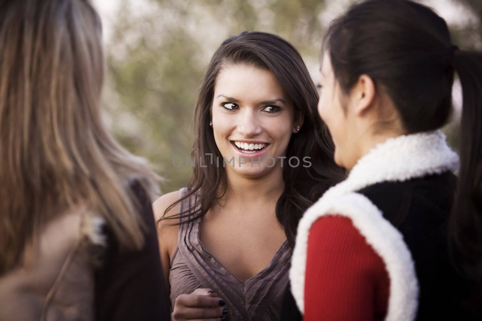 Portrait of three female friends focusing on Hispanic woman