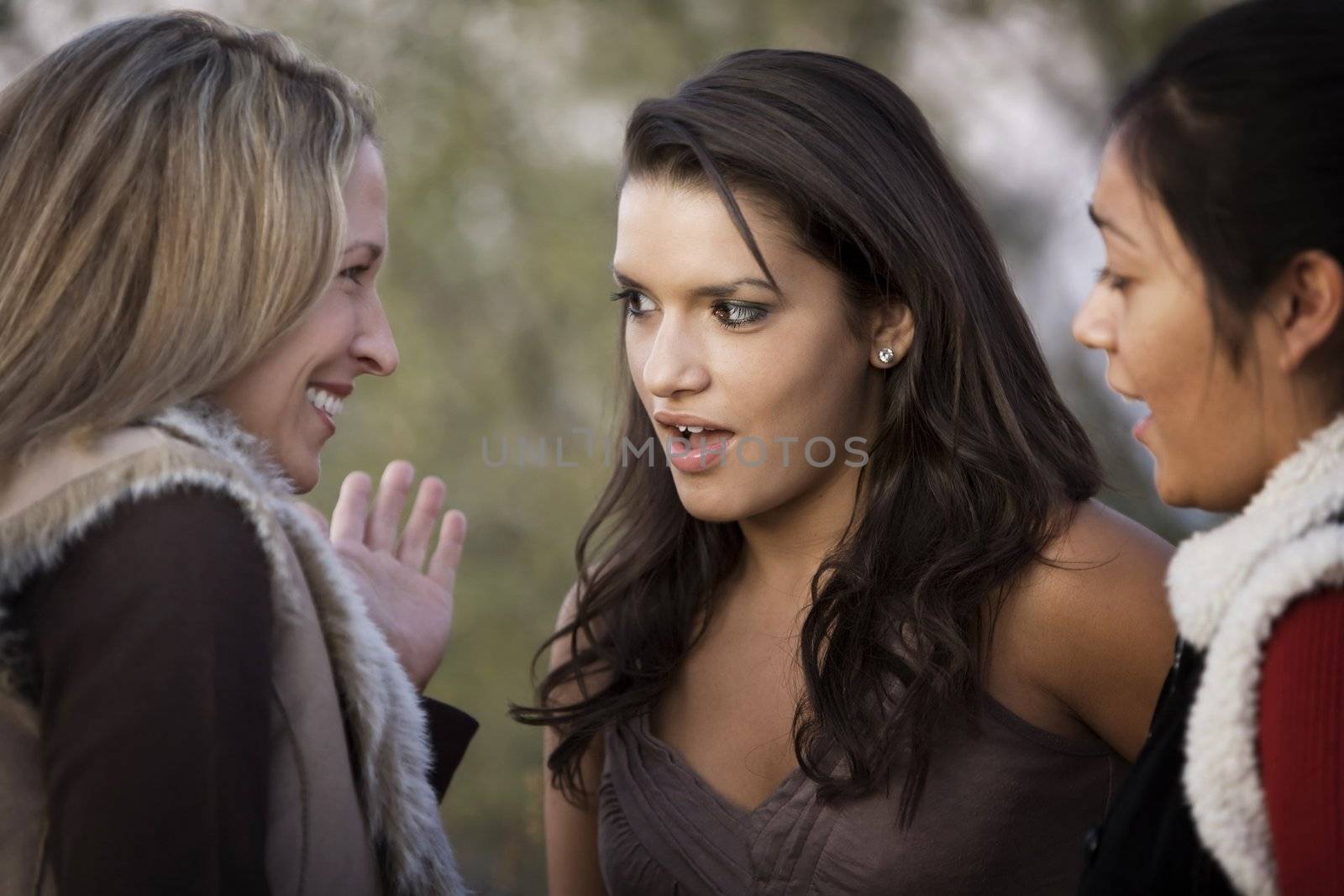 Portrait of three female friends focusing on Hispanic woman