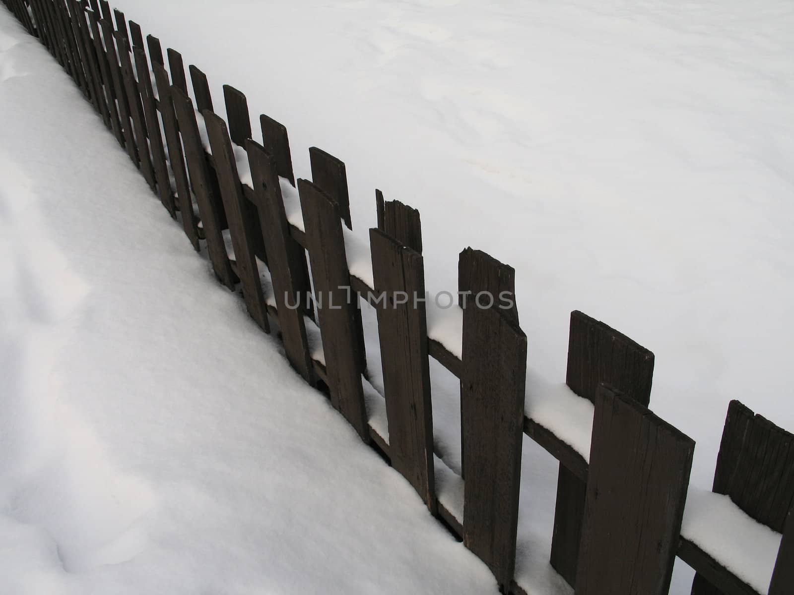 wooden fence with snow by mmm