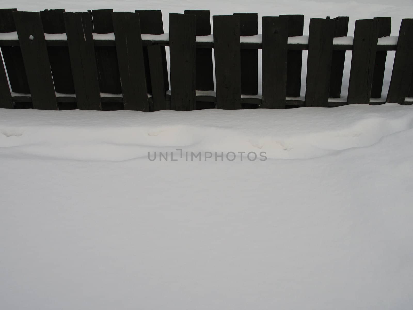 wooden fence with snow by mmm