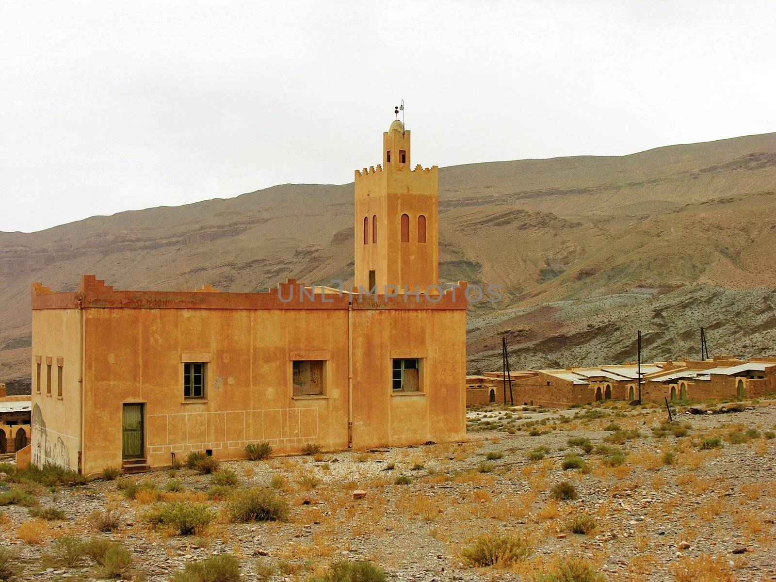 Small remote desert mosque near a village by the mountains