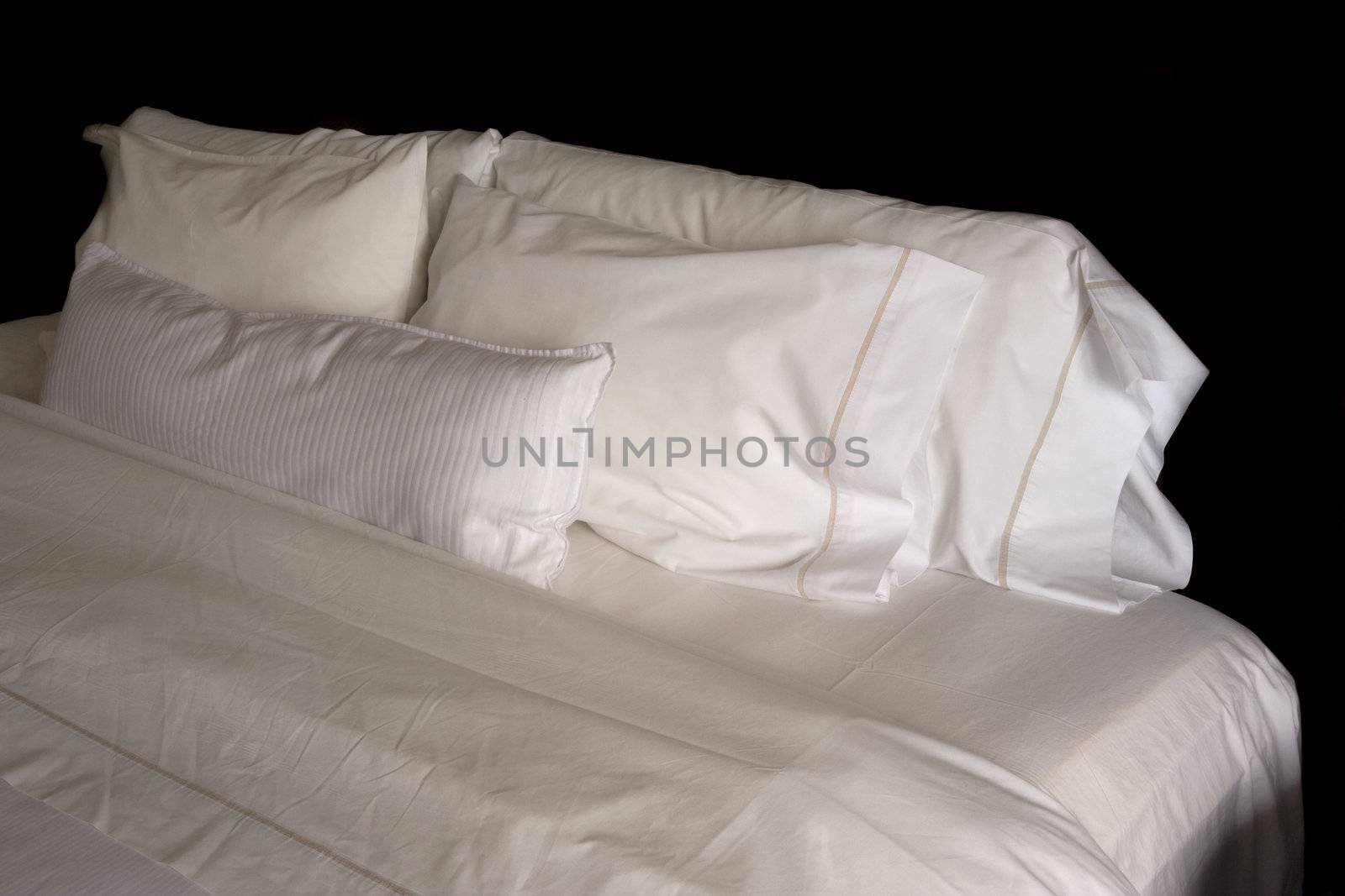 five white pillows on a king size hotel bed