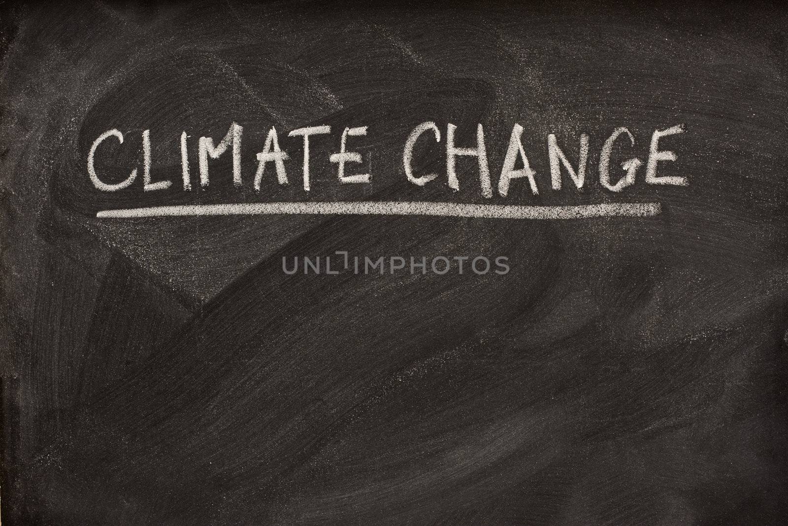 climate change handwriiten with white chalk as a title or subject on blackboard