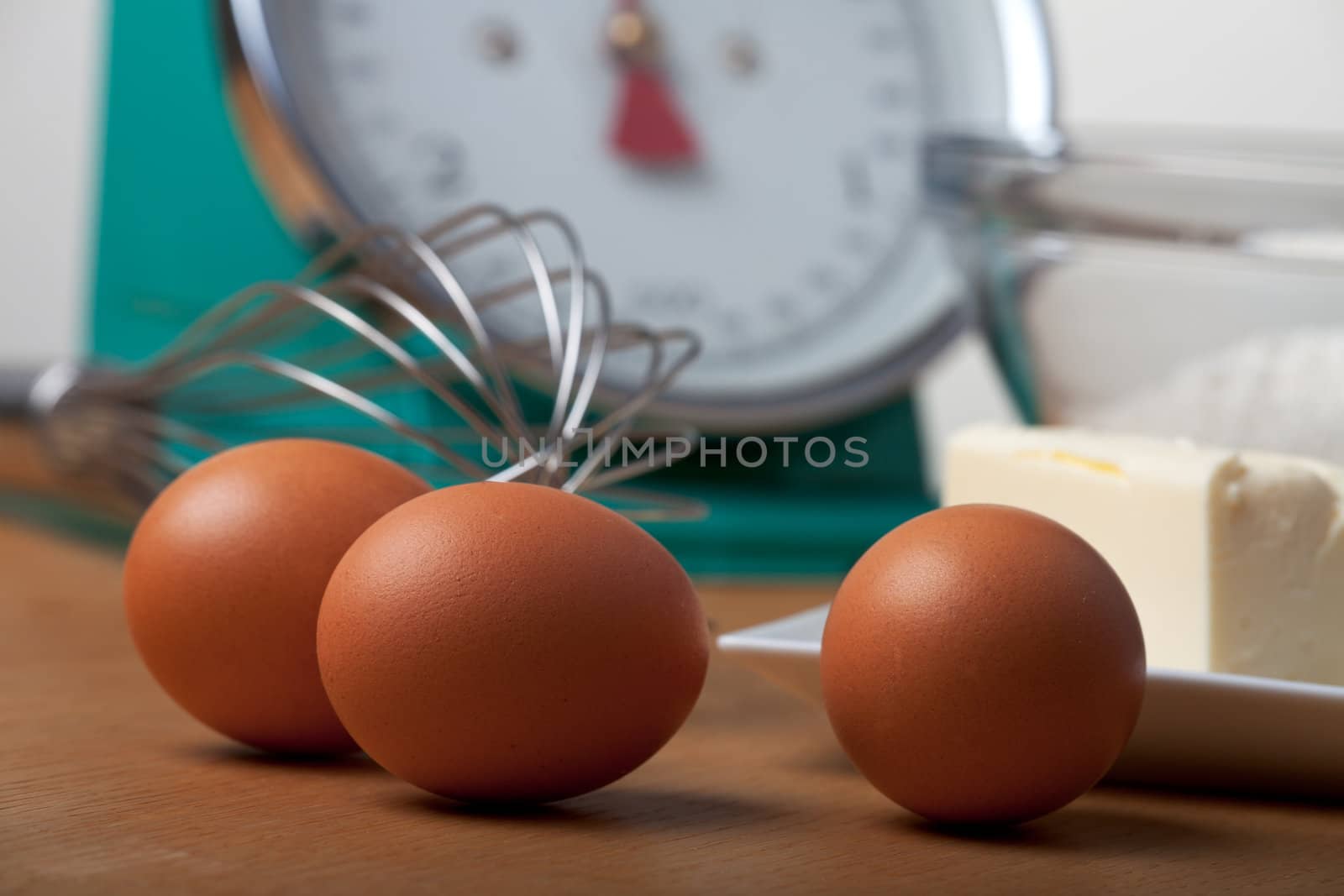 eggs and a eggbeater on a wooden table
