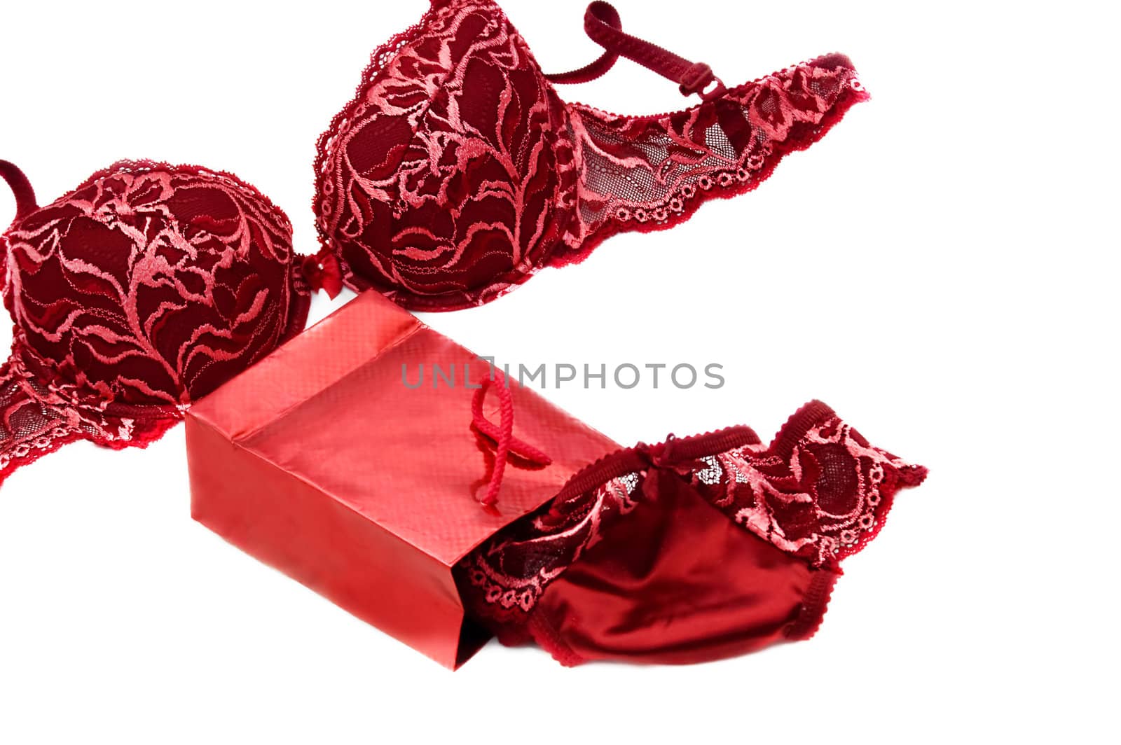red lace silky lingerie near red present box over white