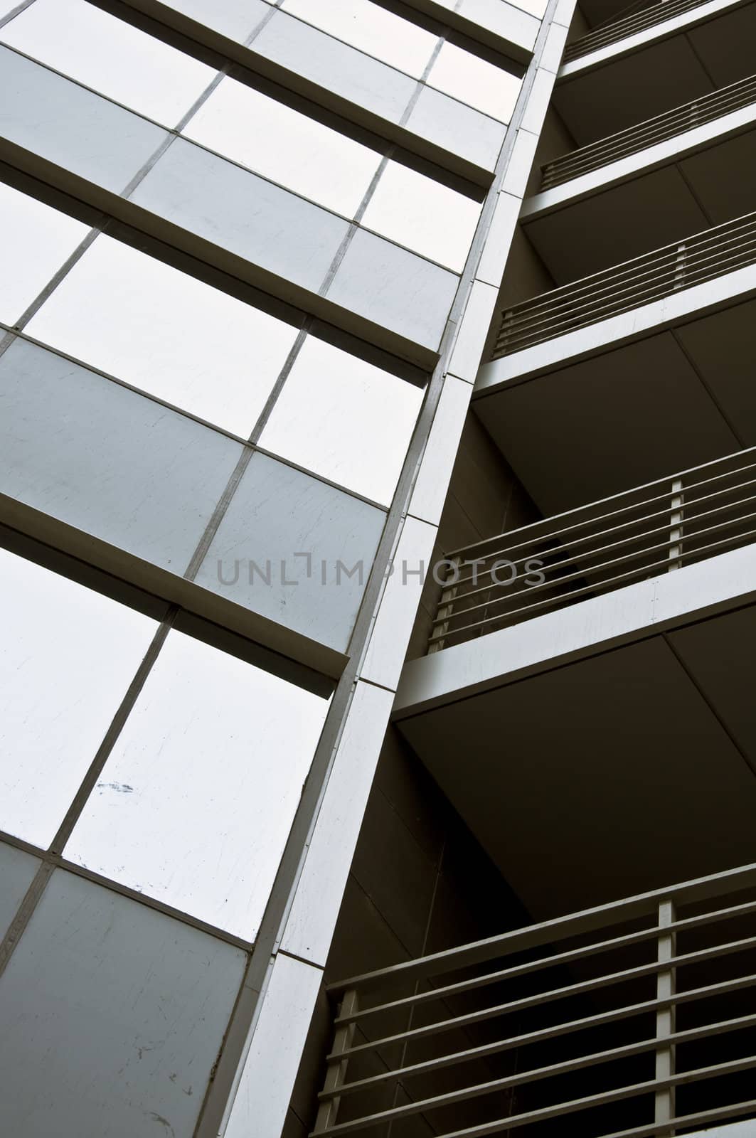 Detail of the facade office building close up. Stained-glass system and hinged front panel.