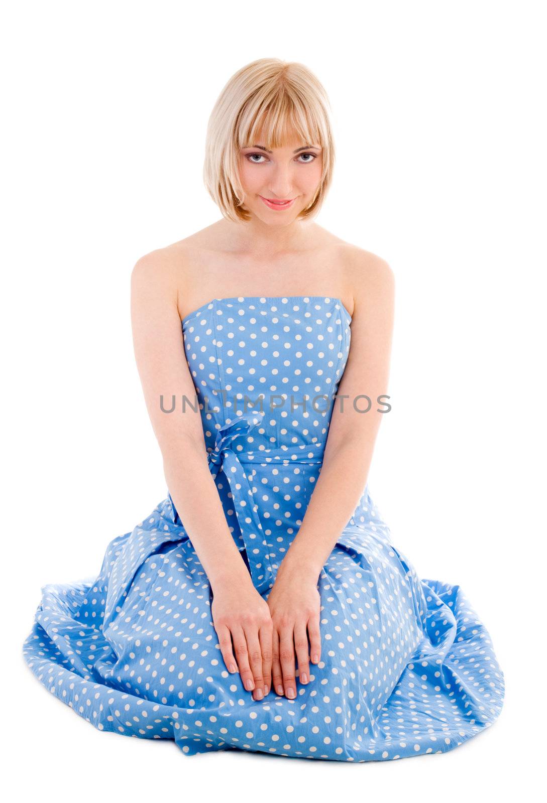 Sitting woman in blue polka dot dress by mihhailov