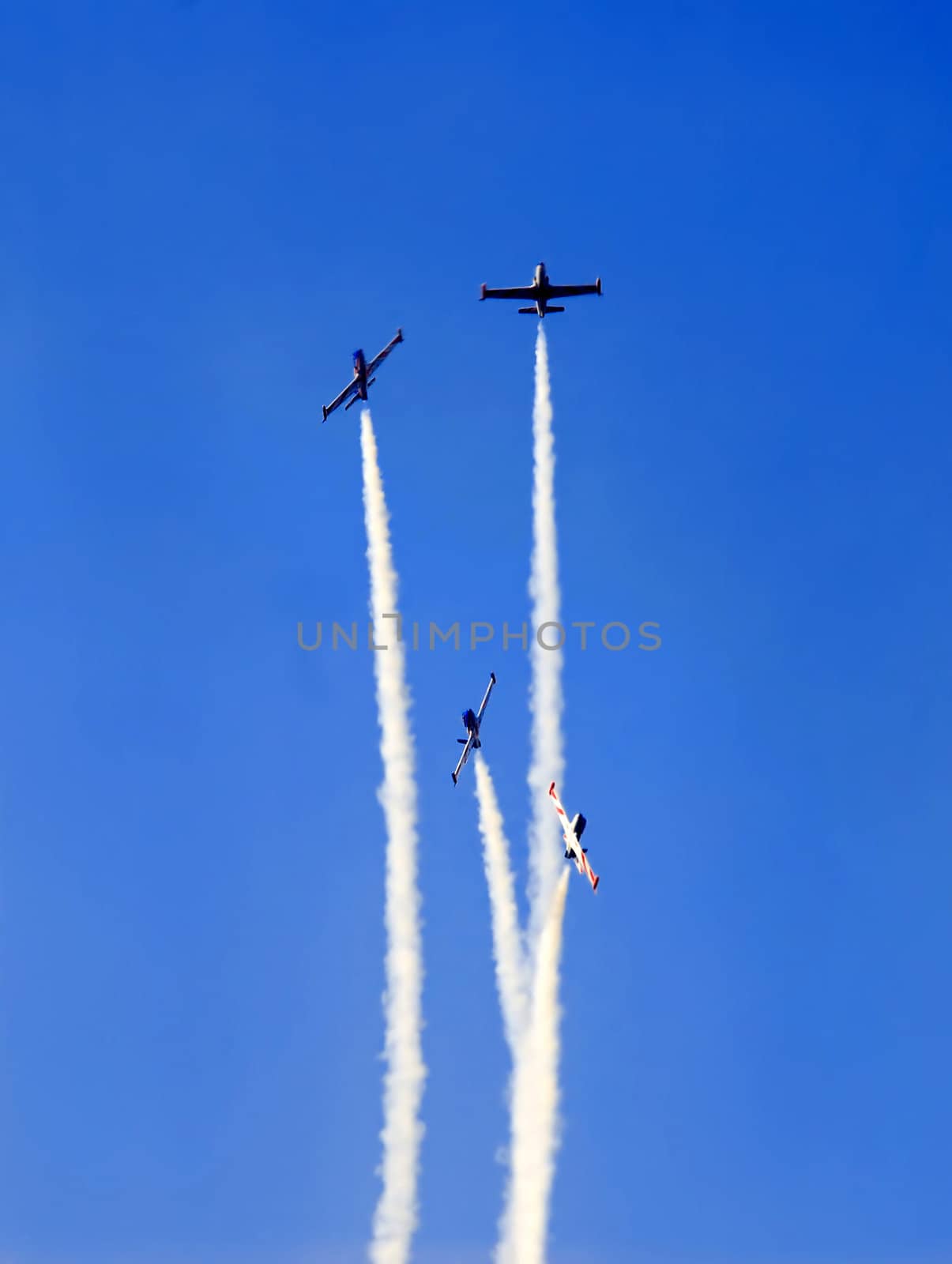 planes group in acrobatic flight with smoke trace over blue sky