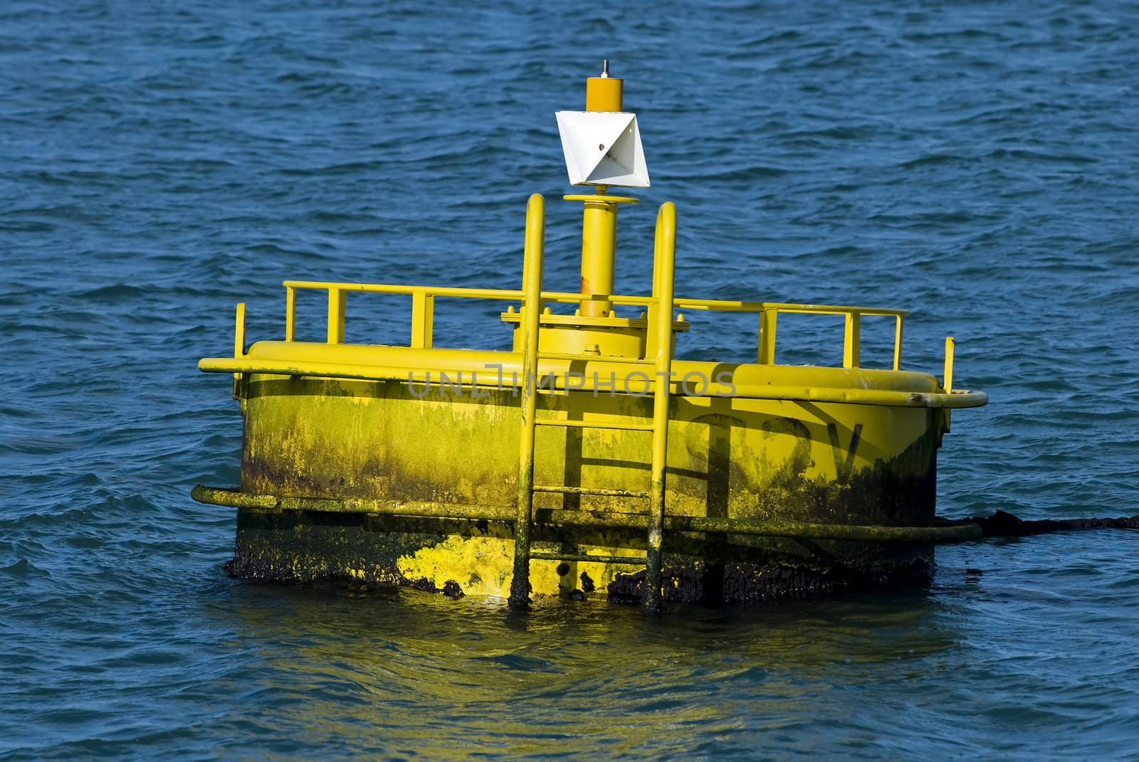 Yellow buoy on a blue water

