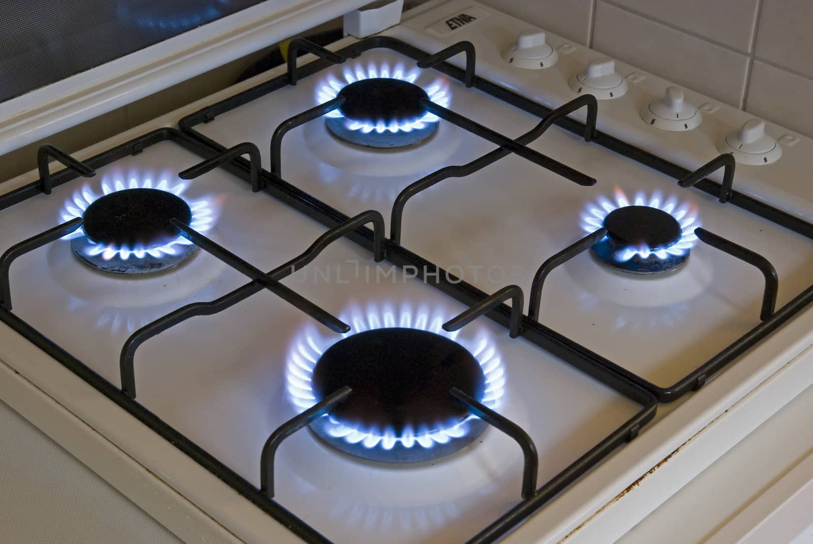 Four blue flames of a gas stove by Gertje