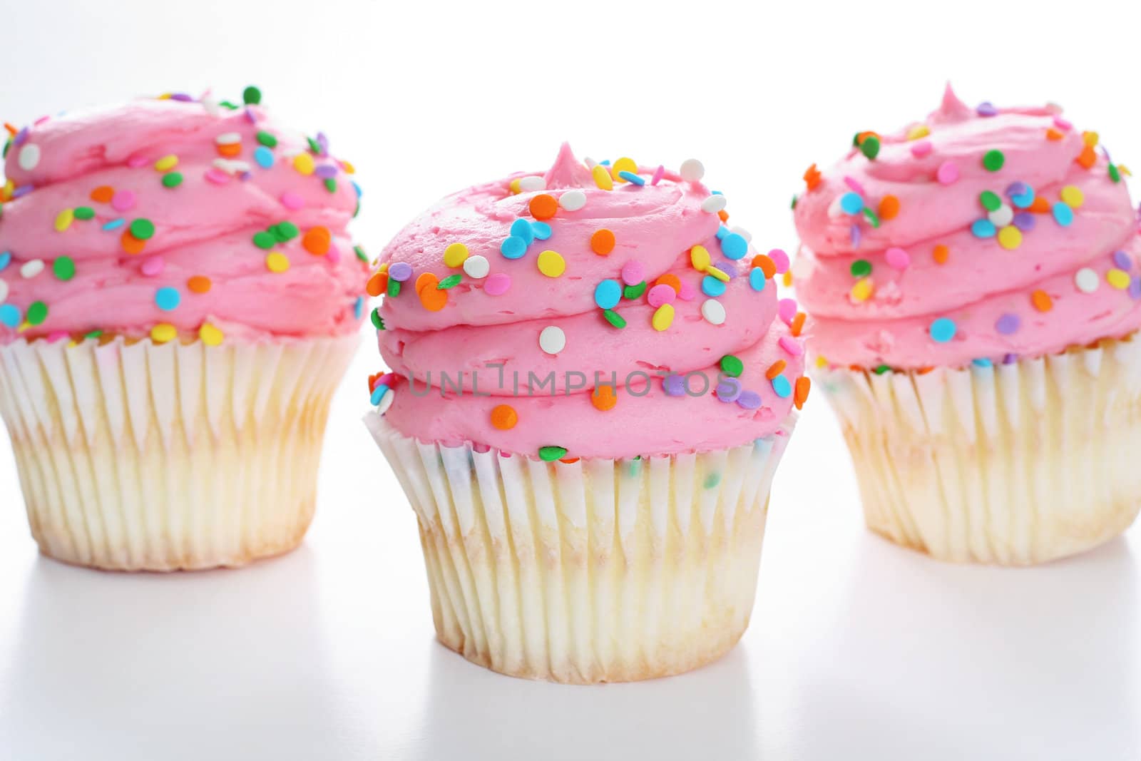 Three cupcakes with sprinkles