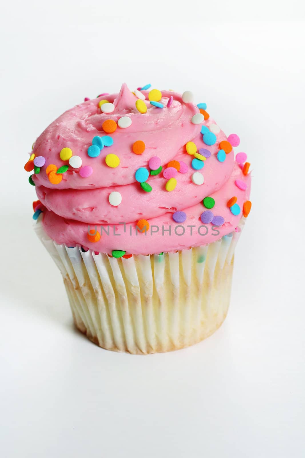 shot of a gourmet pink cupcake up close vertical by creativestock