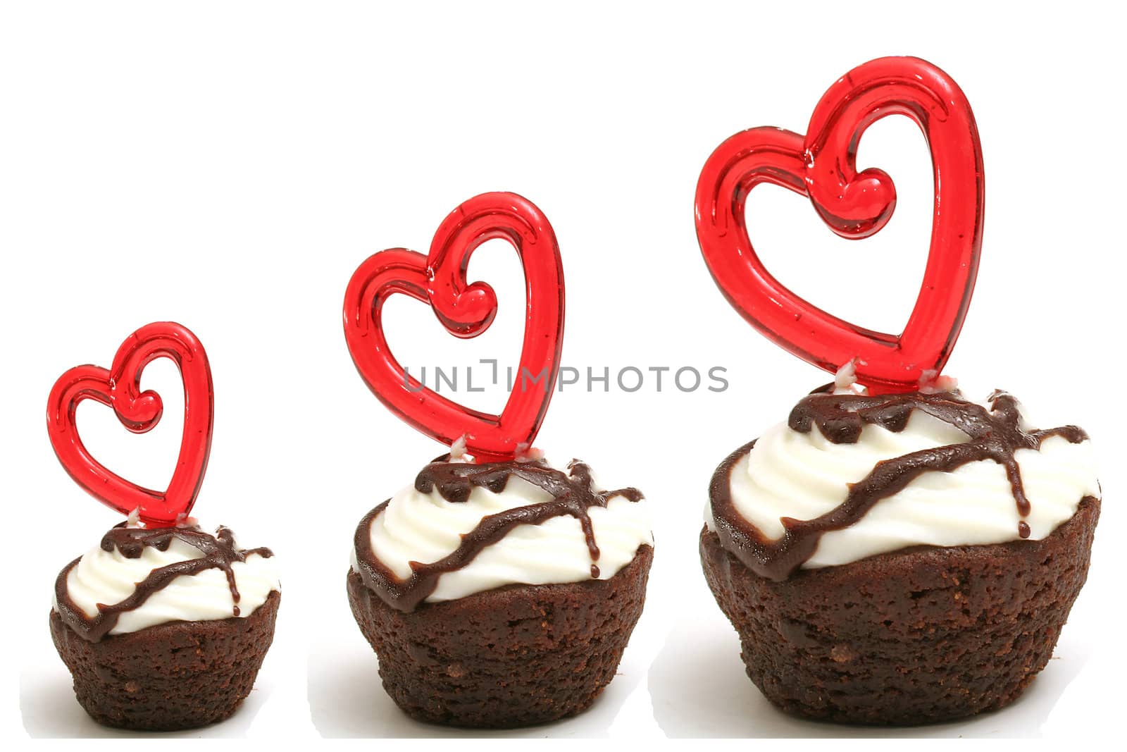 Three heart brownies in a row isolated on white by creativestock