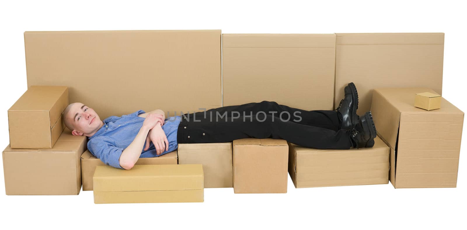 Man lying on sofa from carton box