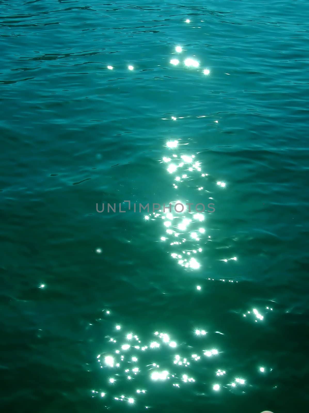 sun reflection on green sea water abstract