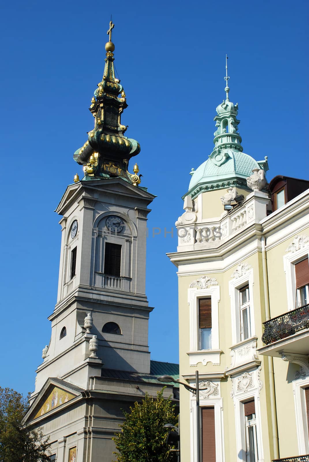 orthodox cathedral and tower of classic building  over blue sky
