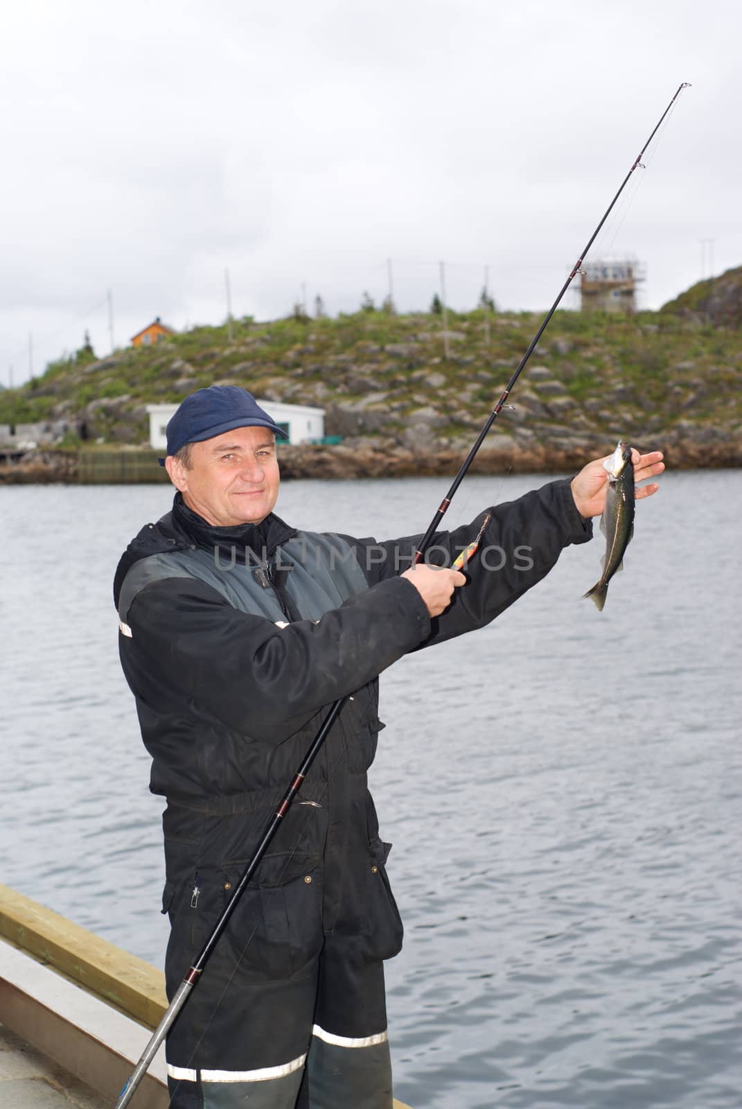 The fisherman on the pier on island Skrova