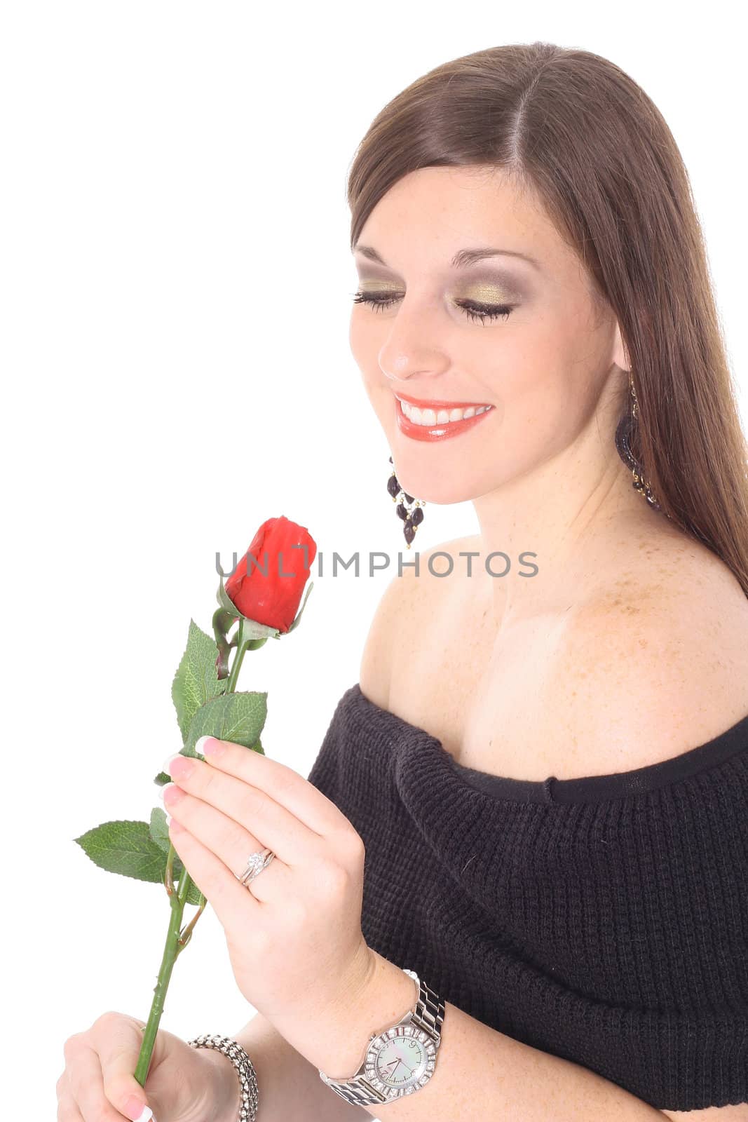 happy brunette smelling a rose