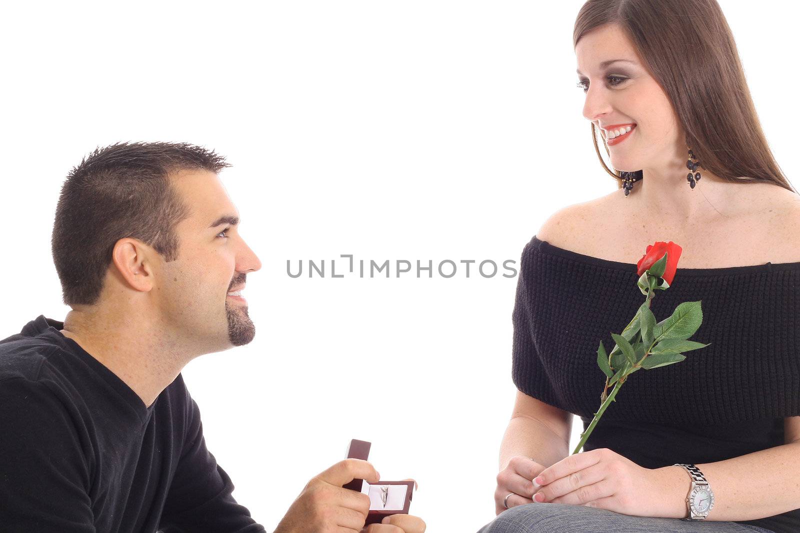 handsome guy proposing with diamond