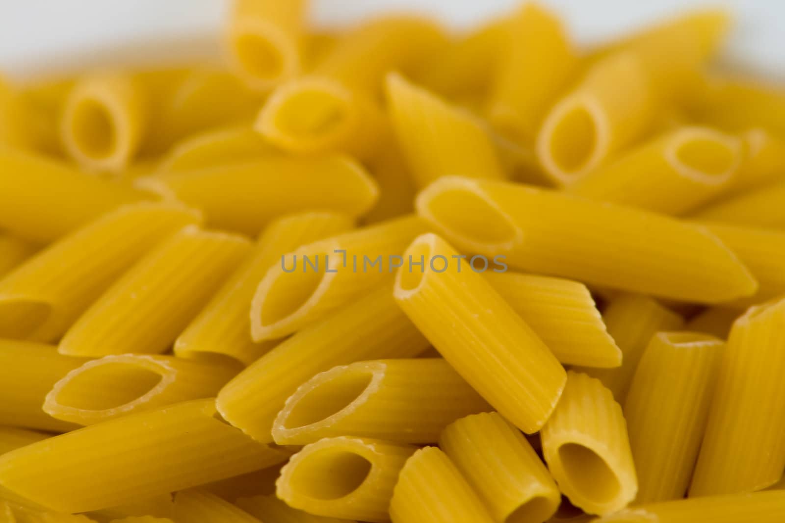 A plate of uncooked "mezze penne", typical Italian pasta