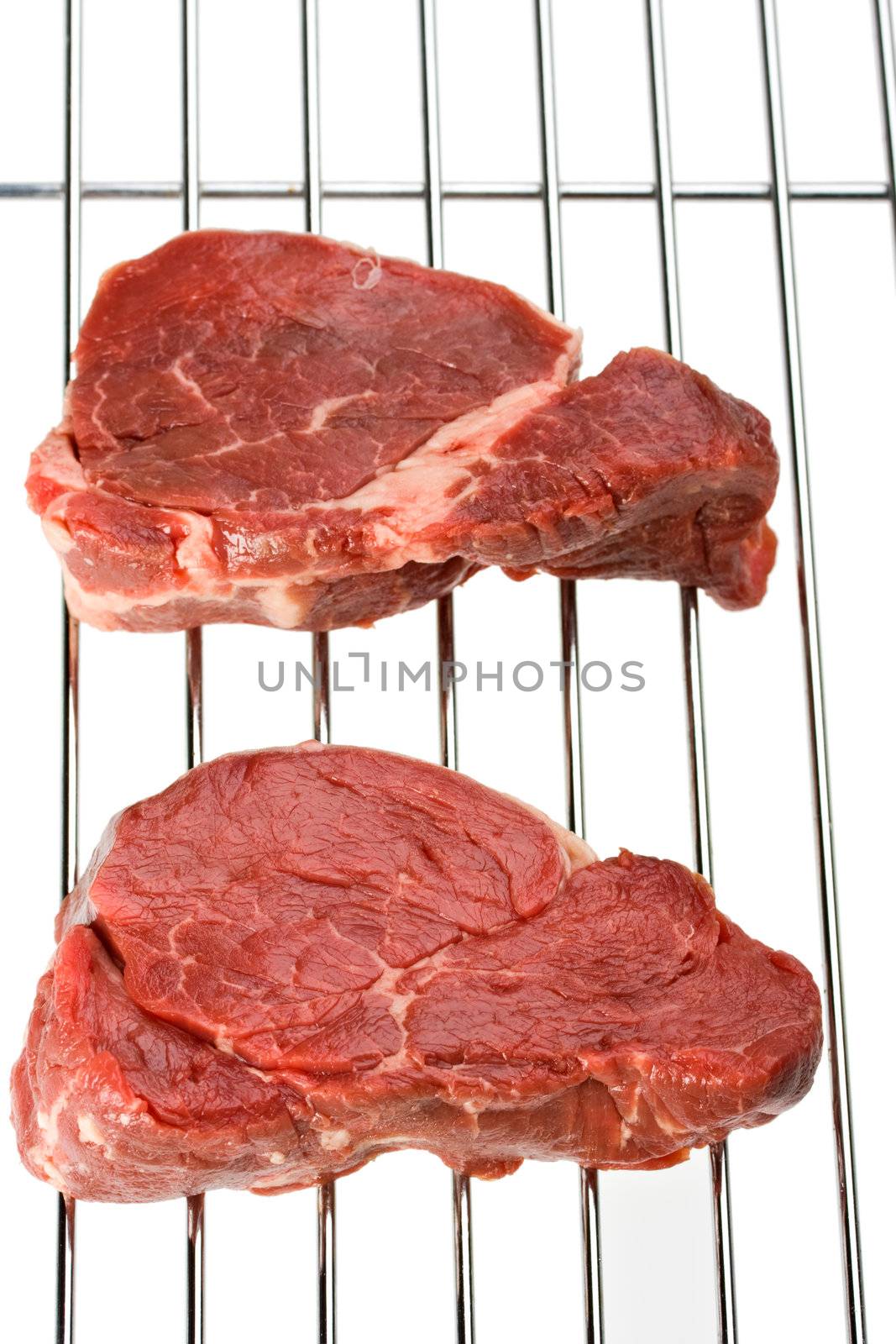 raw steak on a grill isolated on white