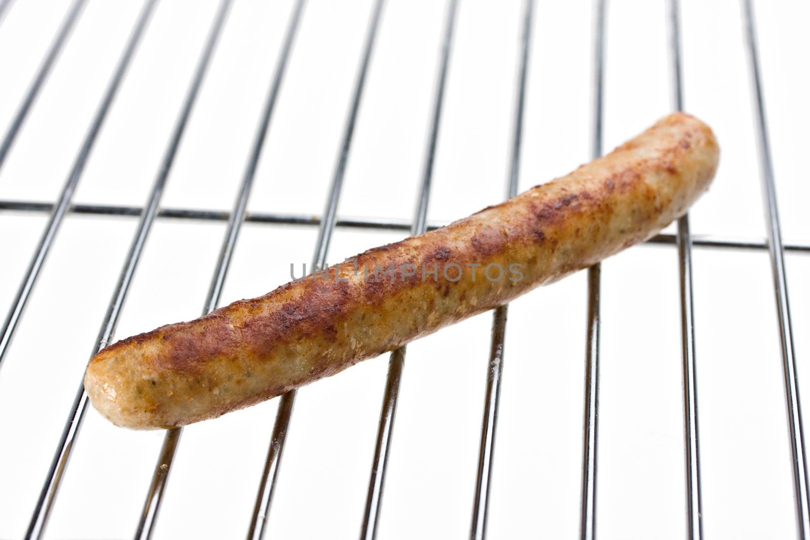 grilled sausage on a grill isolated on white by bernjuer