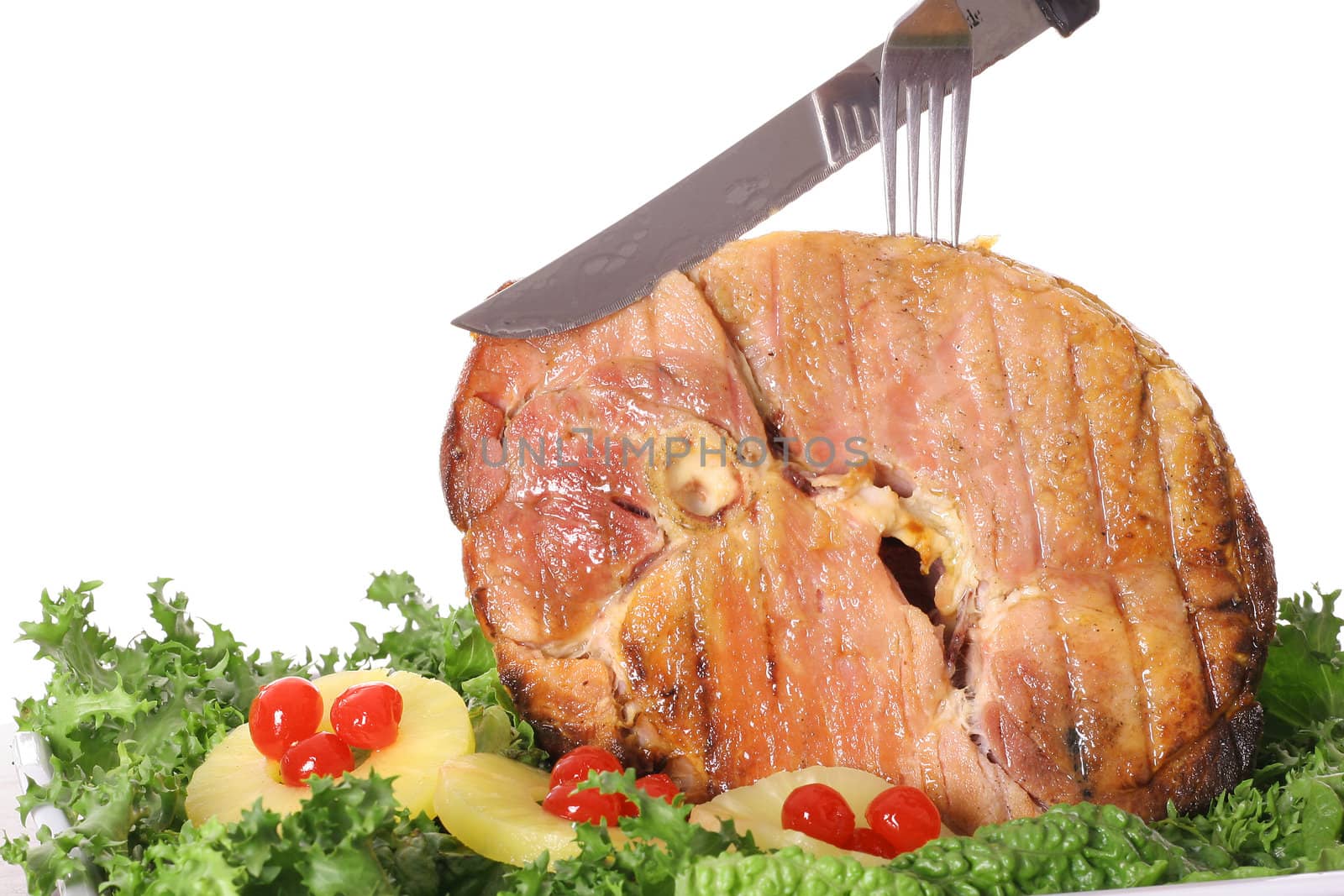 shot of a honey baked ham sliced  by creativestock
