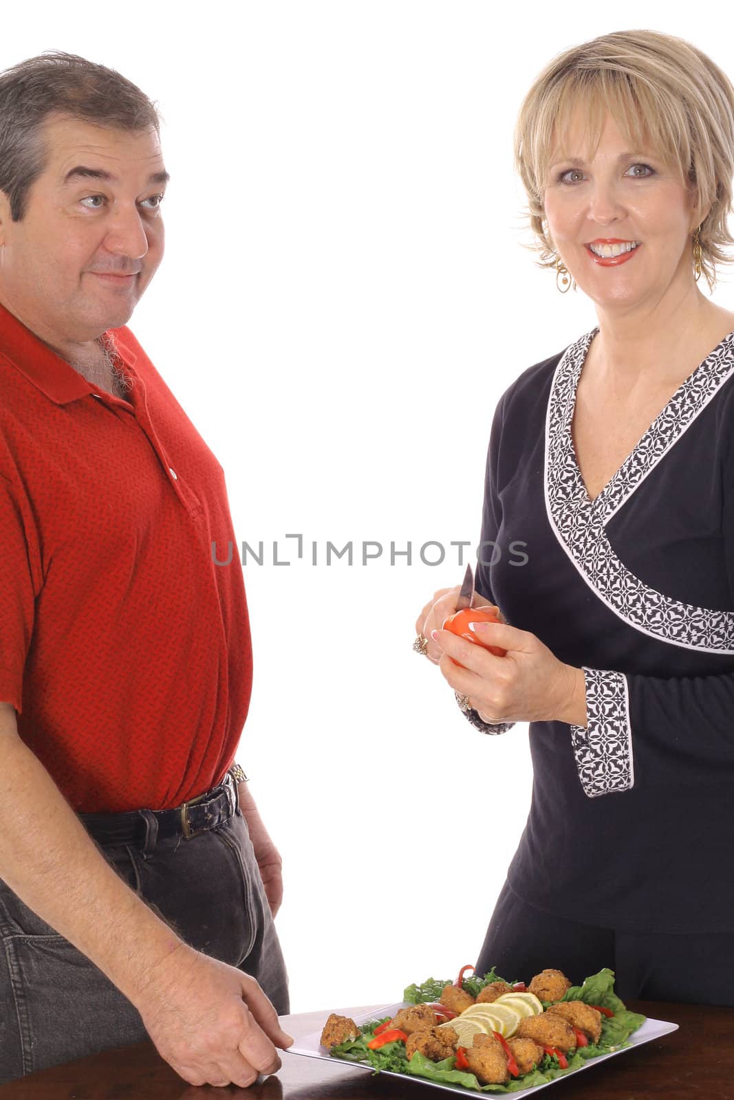 middle age couple with appetizer plate isolated on white by creativestock