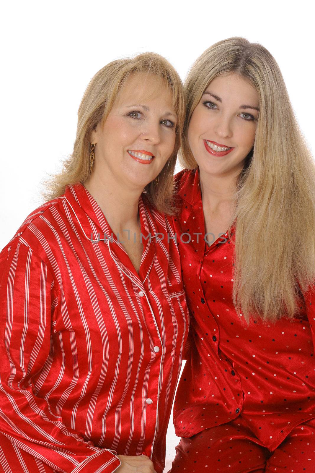 mother and daughter in pajamas isolated on white