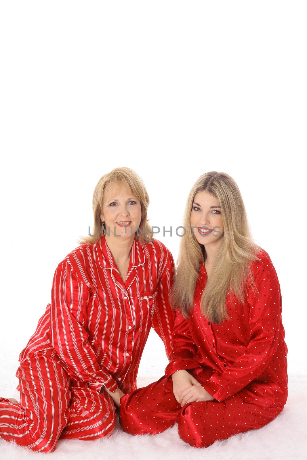 mother and daughter sleepover in pajamas isolated on white by creativestock