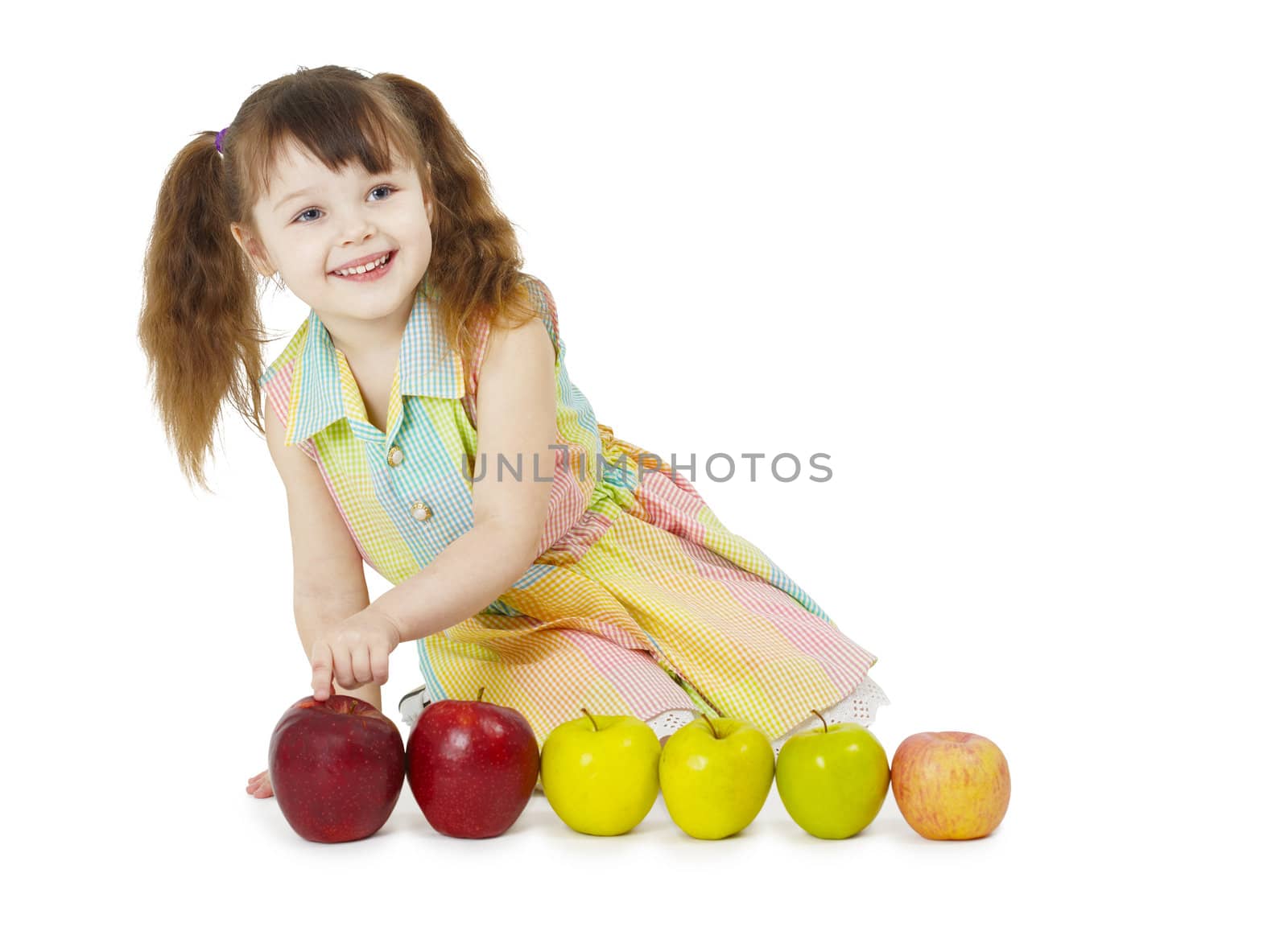Little girl playing with fruits on a white background