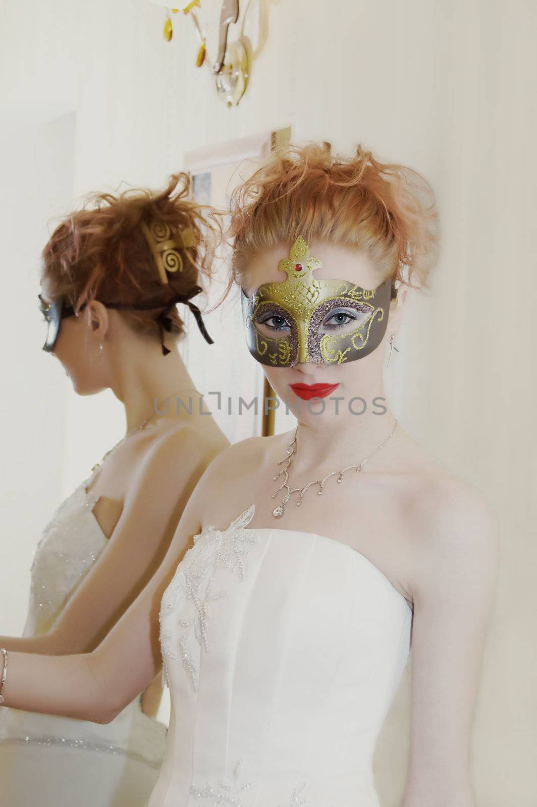 Grunge shot of young red-head with mask and white dress