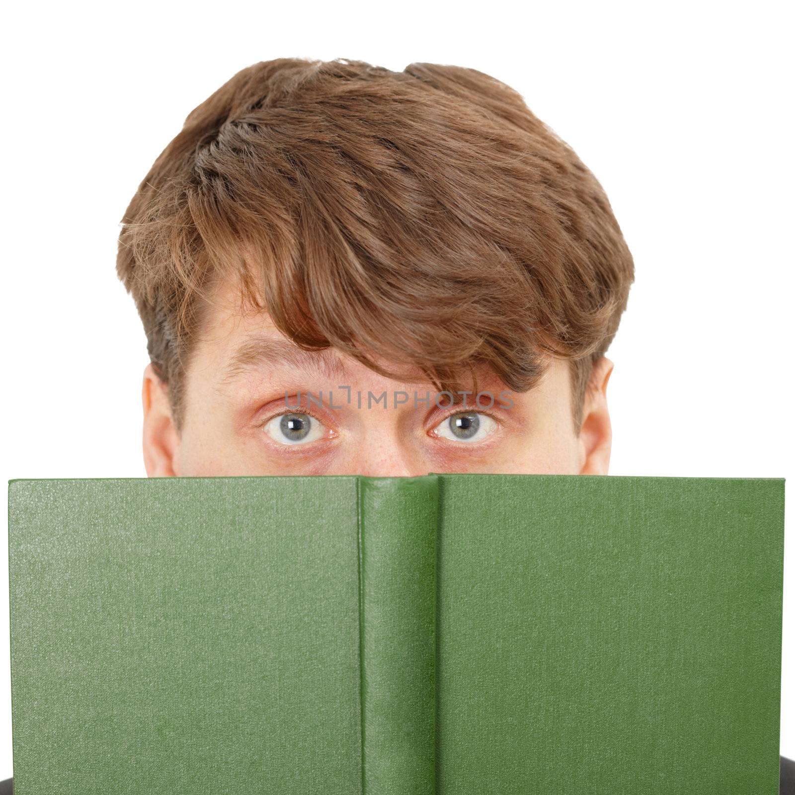 The young man hid his face behind a green book, close-up on a white background