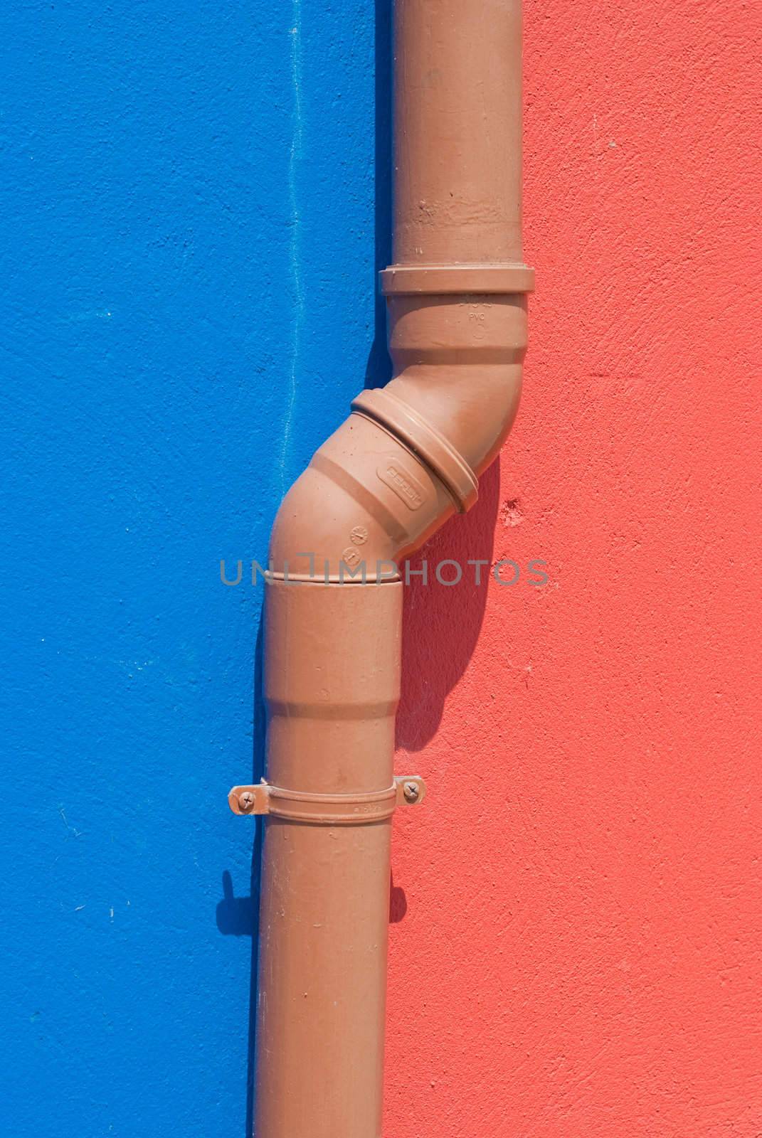 Plumbing pipe on two color wall / abstract grungy background