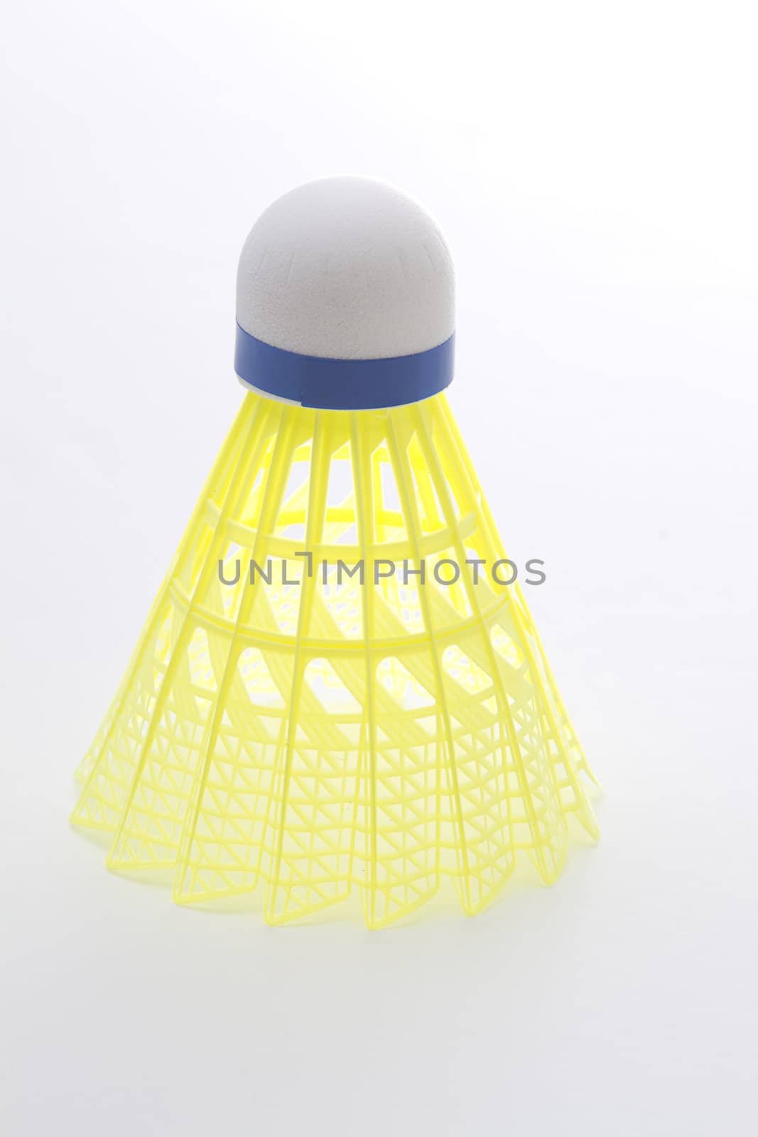 shuttlecock with yellow base in perfect form standing upright