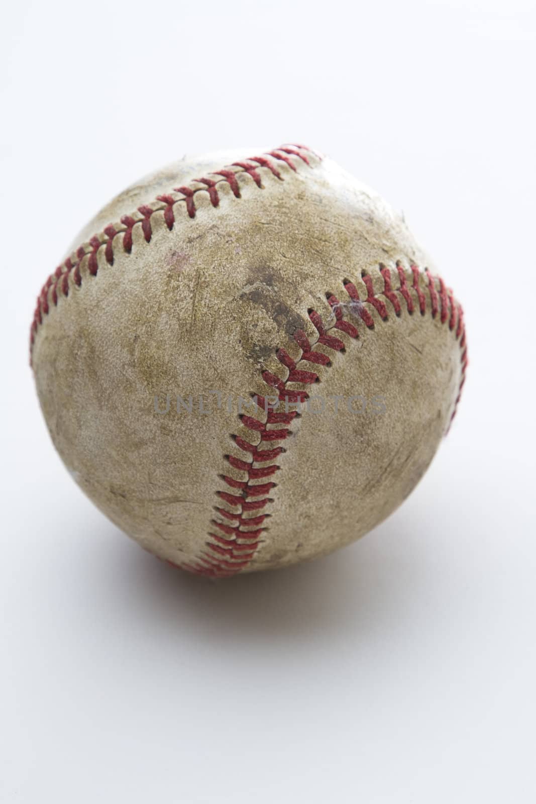 old battle scared baseball against white background