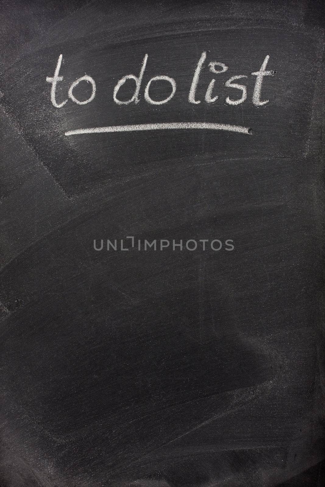 to do list title handritten with white chalk on blackboard with copy space below