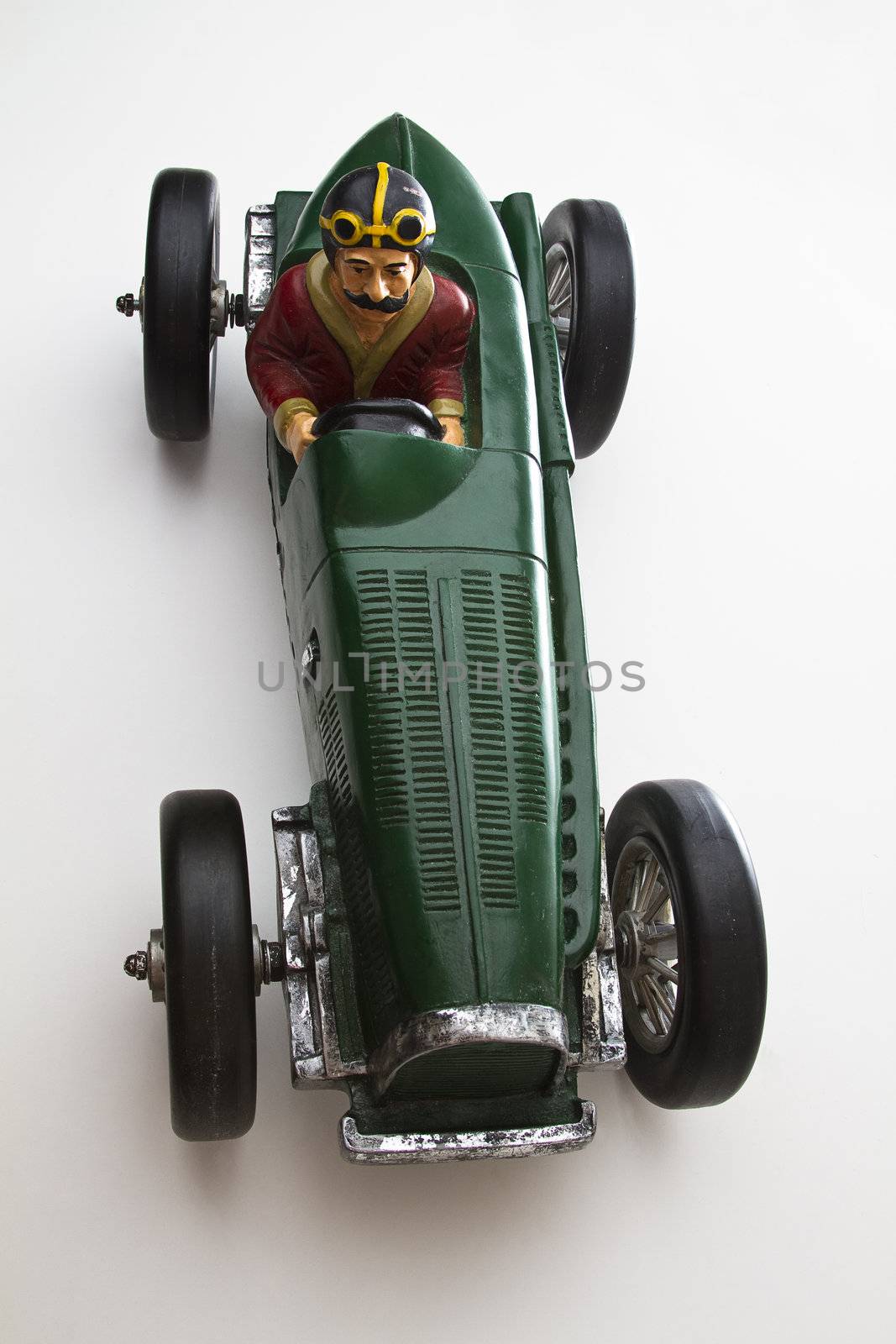 vintage toy race car with mustache driver
