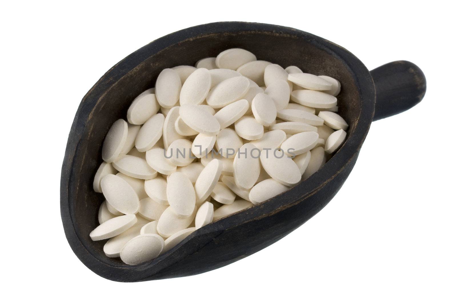 white pills of dietary supplement (papaya enzyme) on a rustic, wooden scoop, isolated on white