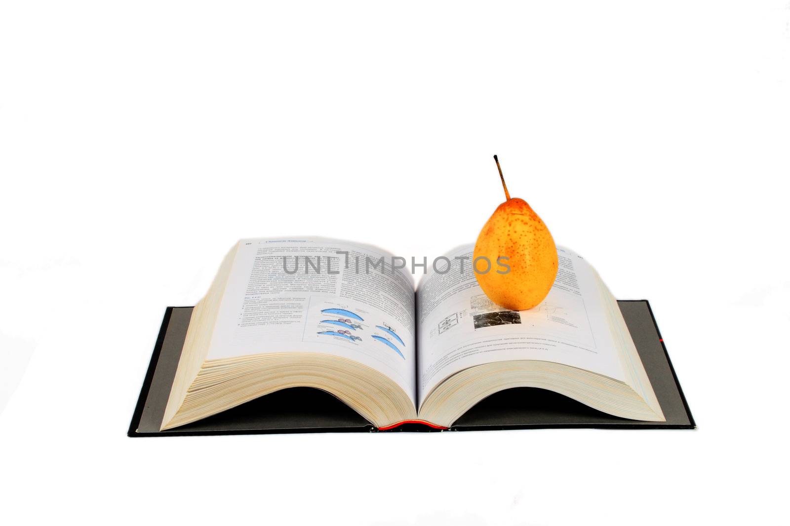 open book and yellow pear isolated over white