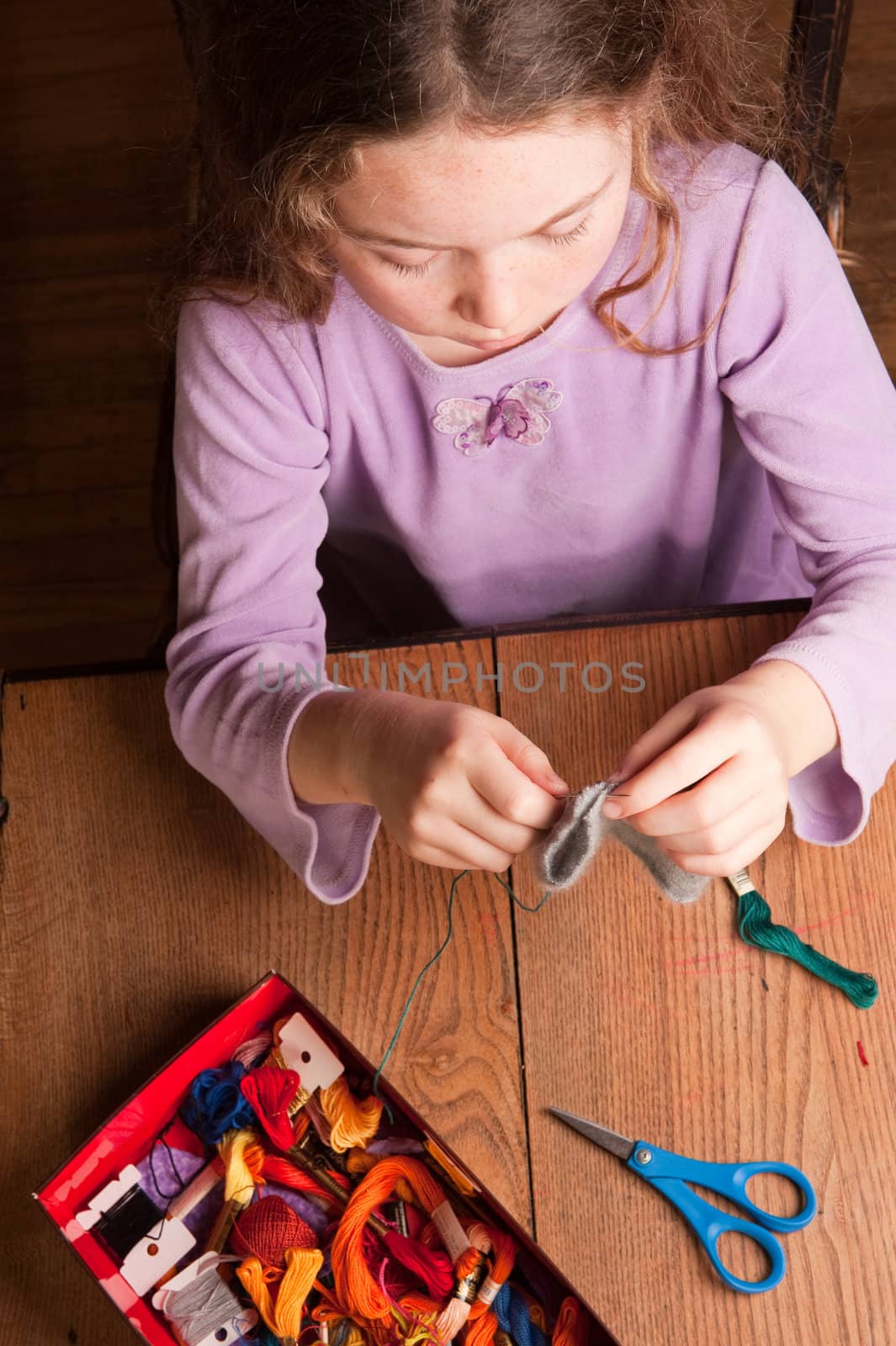 young girl sewing by rongreer