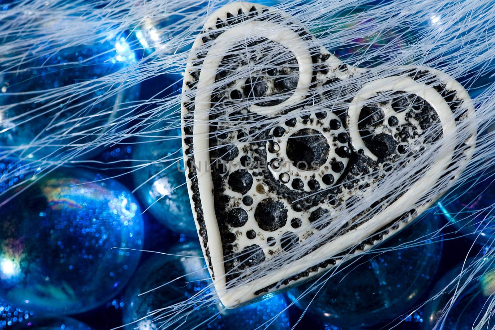 The white ivory heart on the blue crystals