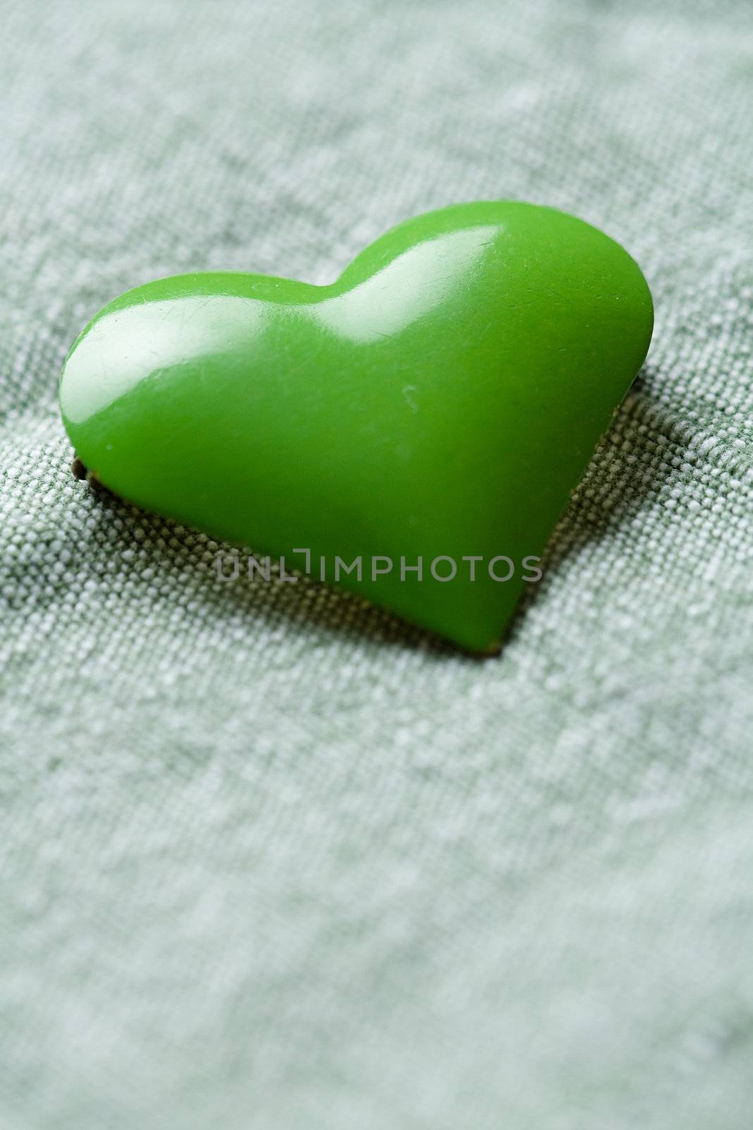The green iron heart on the cloth background