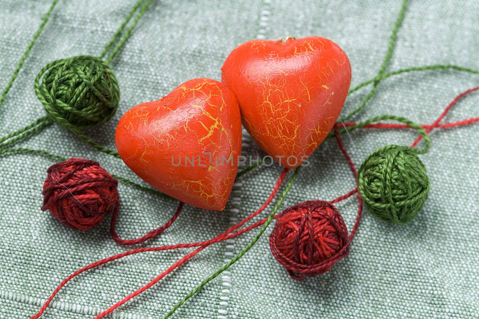 Two red hearts with the four clews on the cloth background