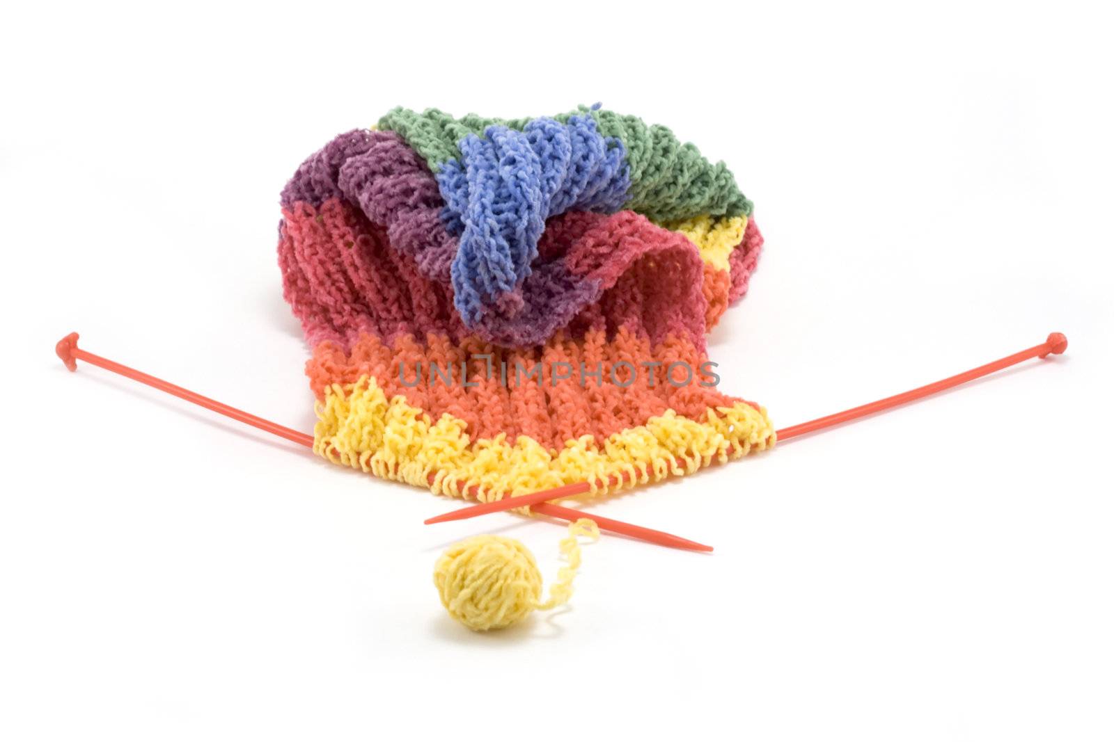 Knitted colour scarf, wool, spokes on white background