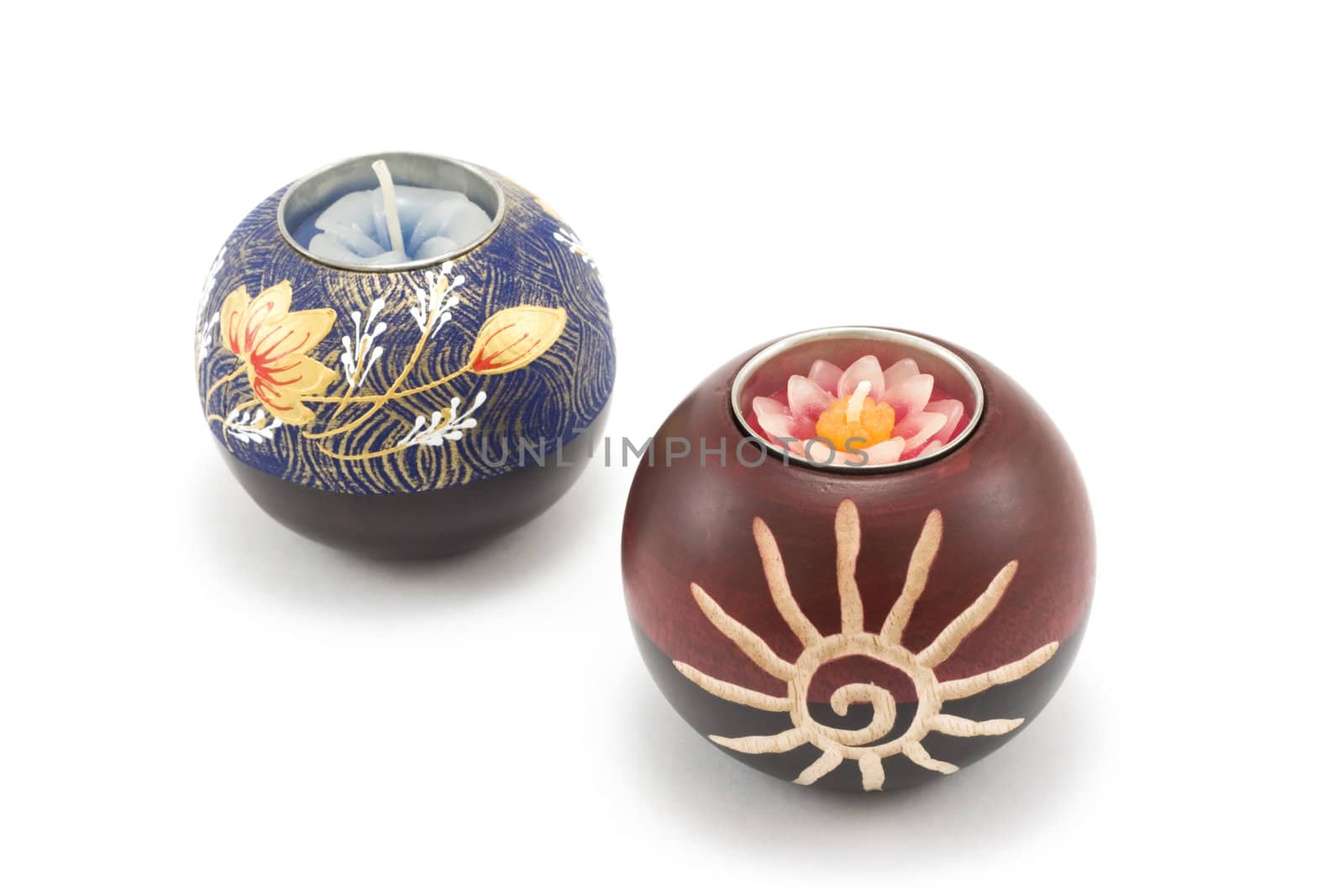 Two candlesticks, wooden balls with candle on white background