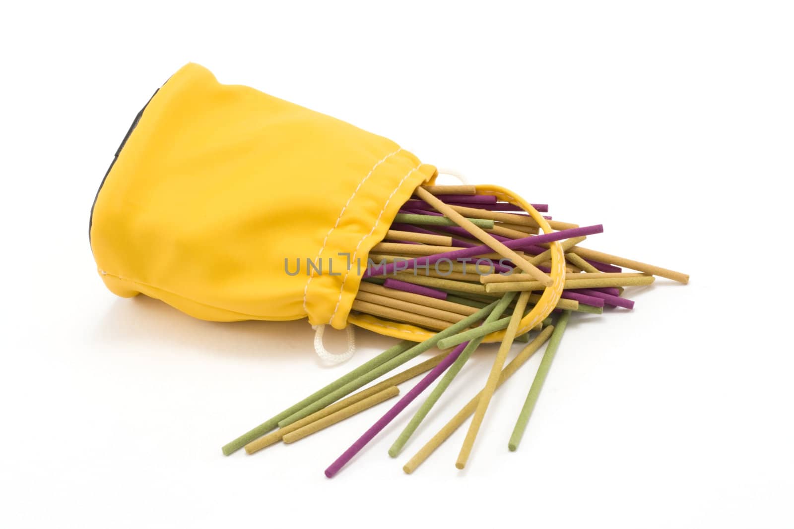 Yellow sac pervaded aromatic stick on white background