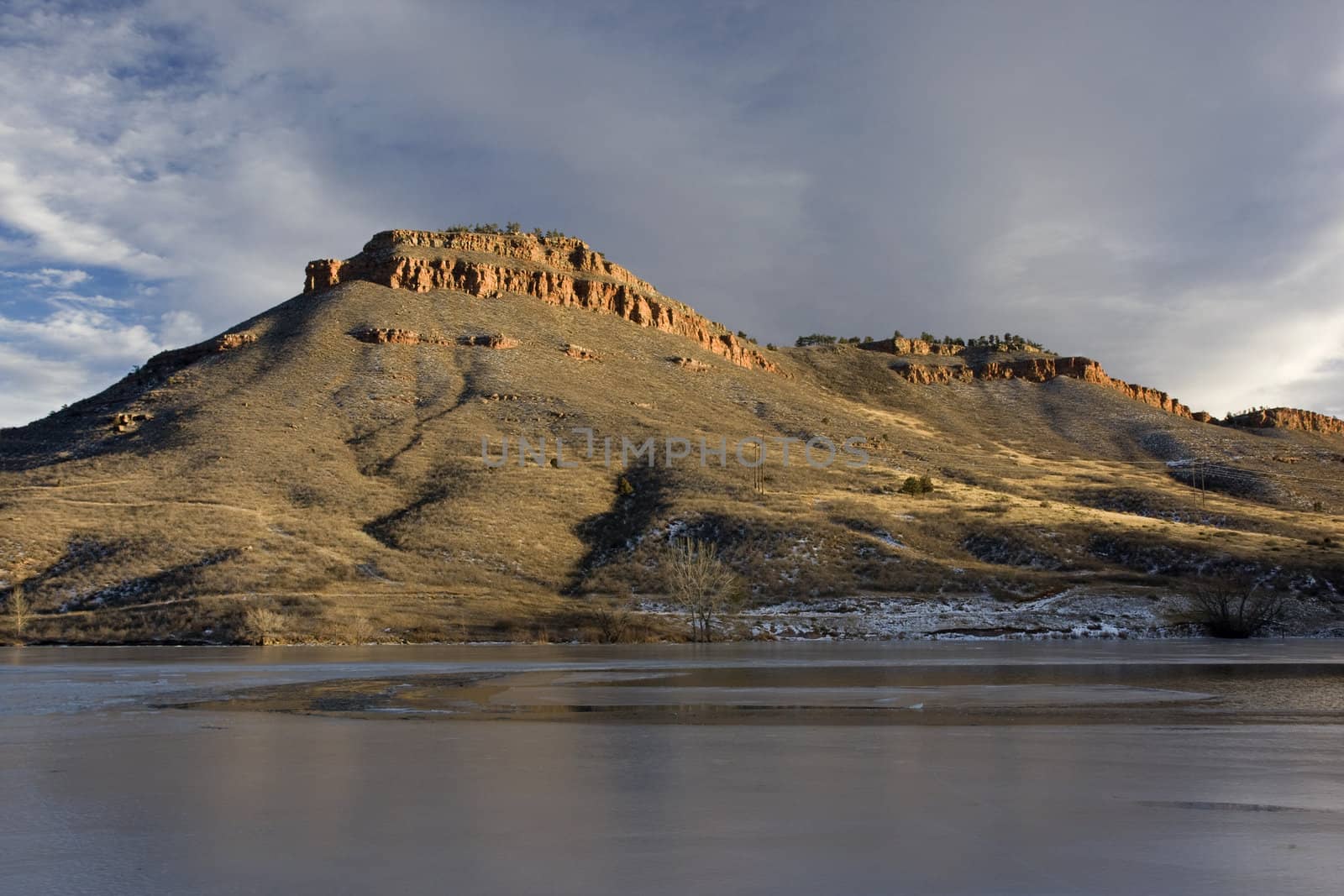hills, sandstone cliffs and freezing lake in Colorado by PixelsAway