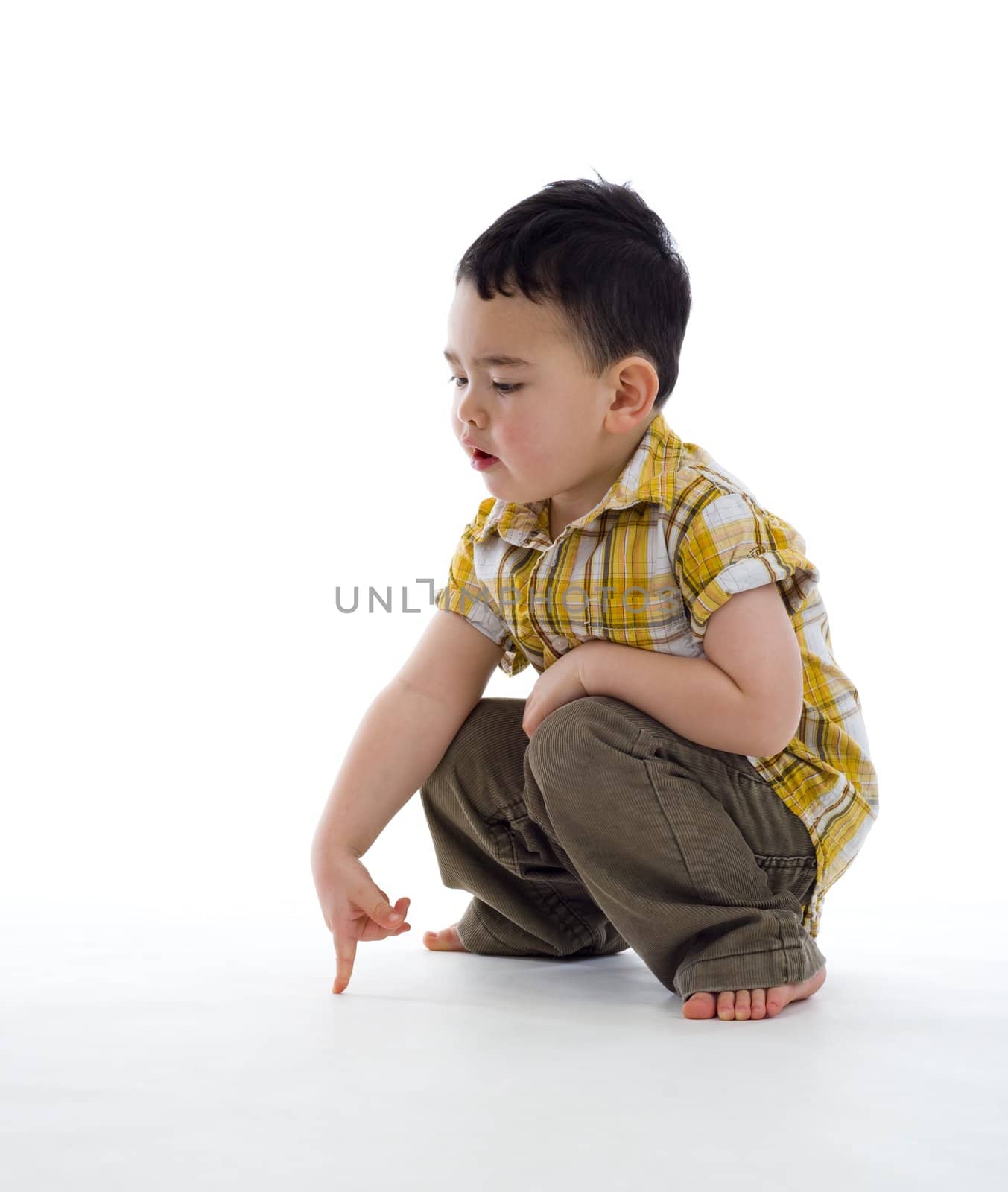 small boy pointing at something, isolated on white